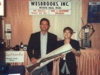 Lori Wesbrooks Stone with the lucky winner of a shotgun at the 1992 CASI Quick Lube Show in West Palm Beach.