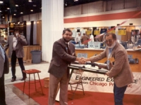 Bob Wesbrooks presents a rifle to a customer at the 1990 NATSO Truck Stop Show in Las Vegas.
